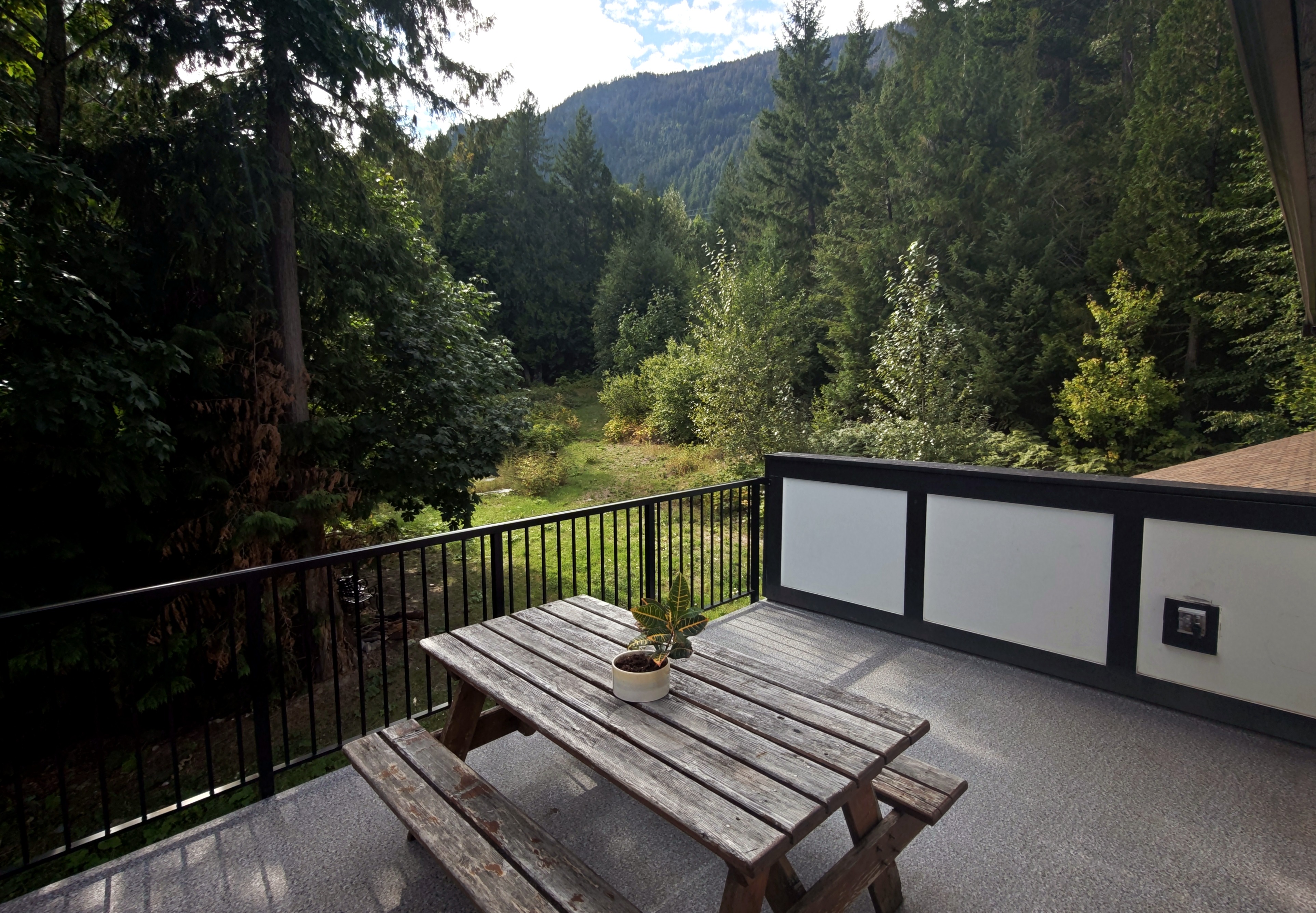 Deck overlooking forested mountains at the retreat estate