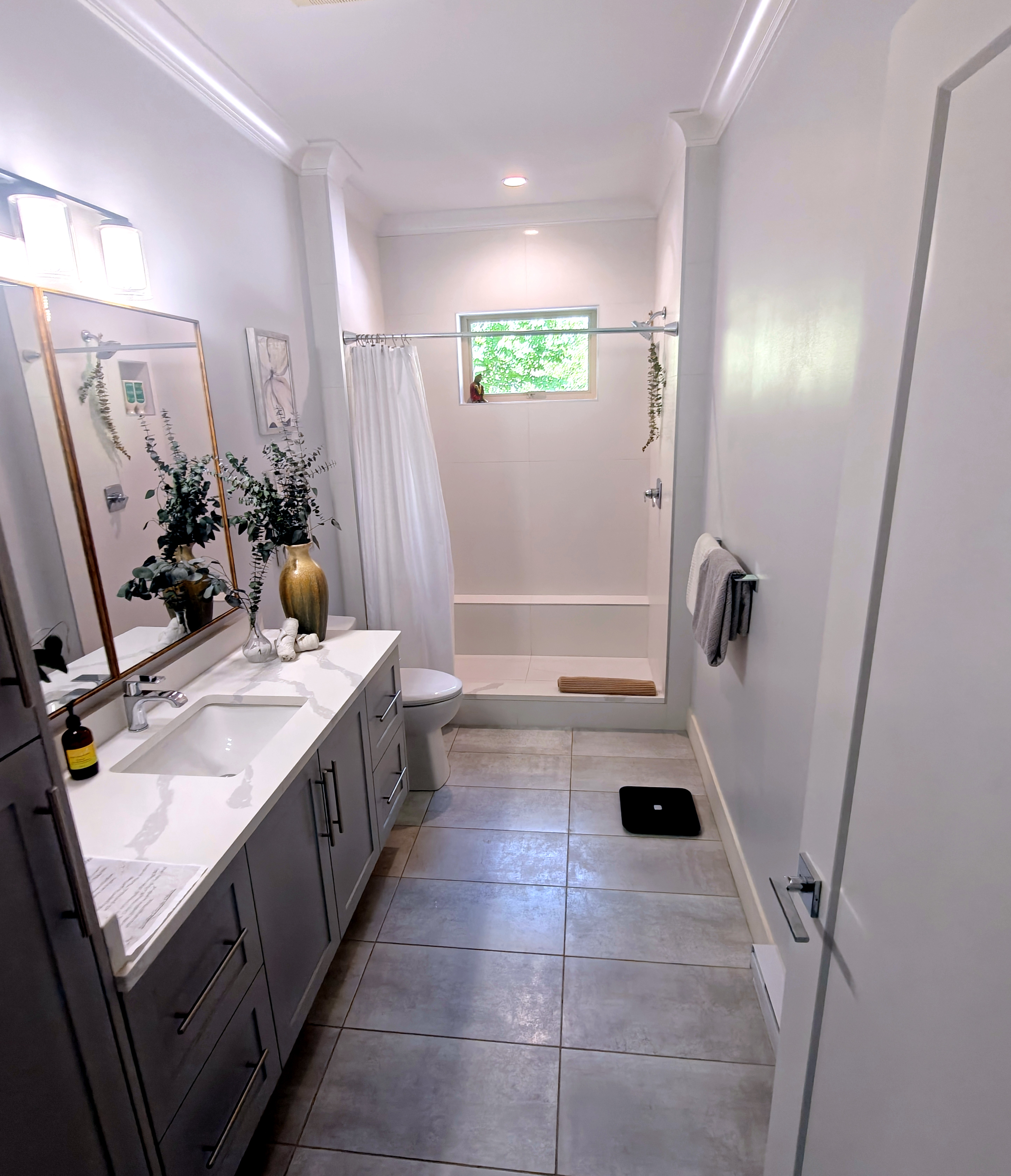 Bathroom with double-sink vanity and tiled shower