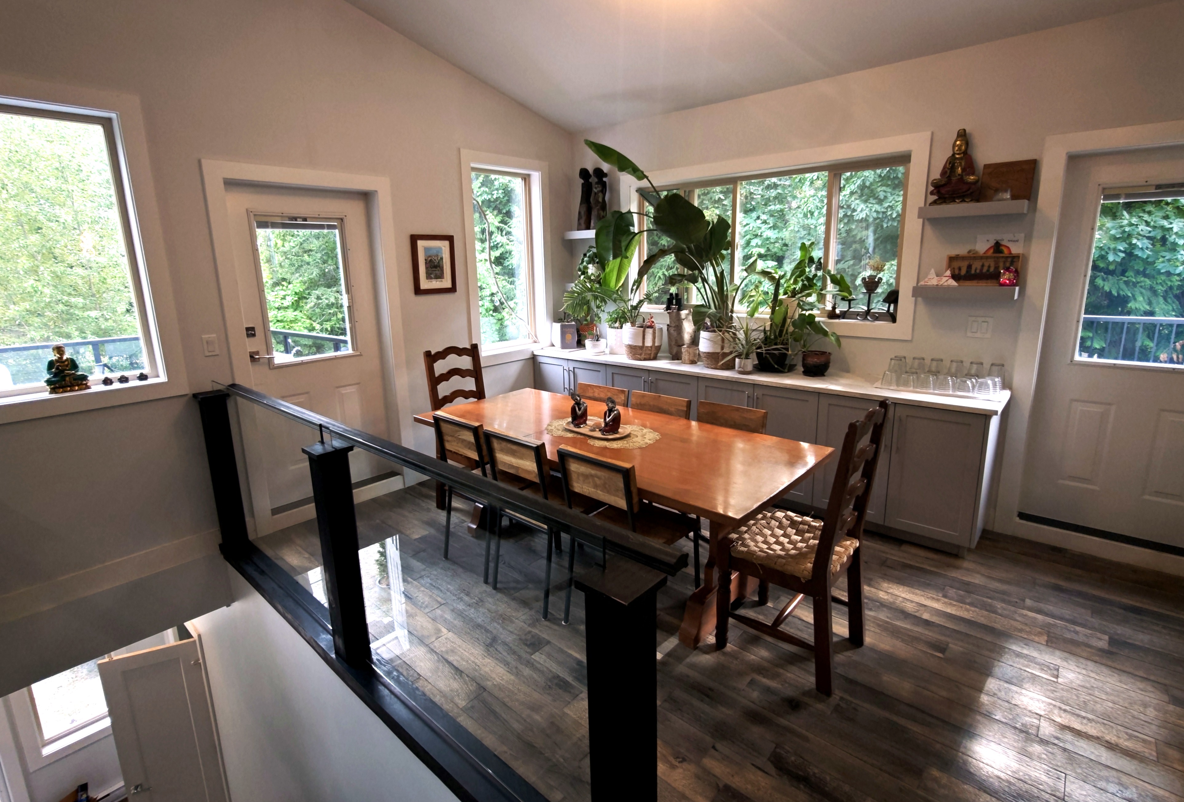 Dining table viewed from the loft, with doors to the deck