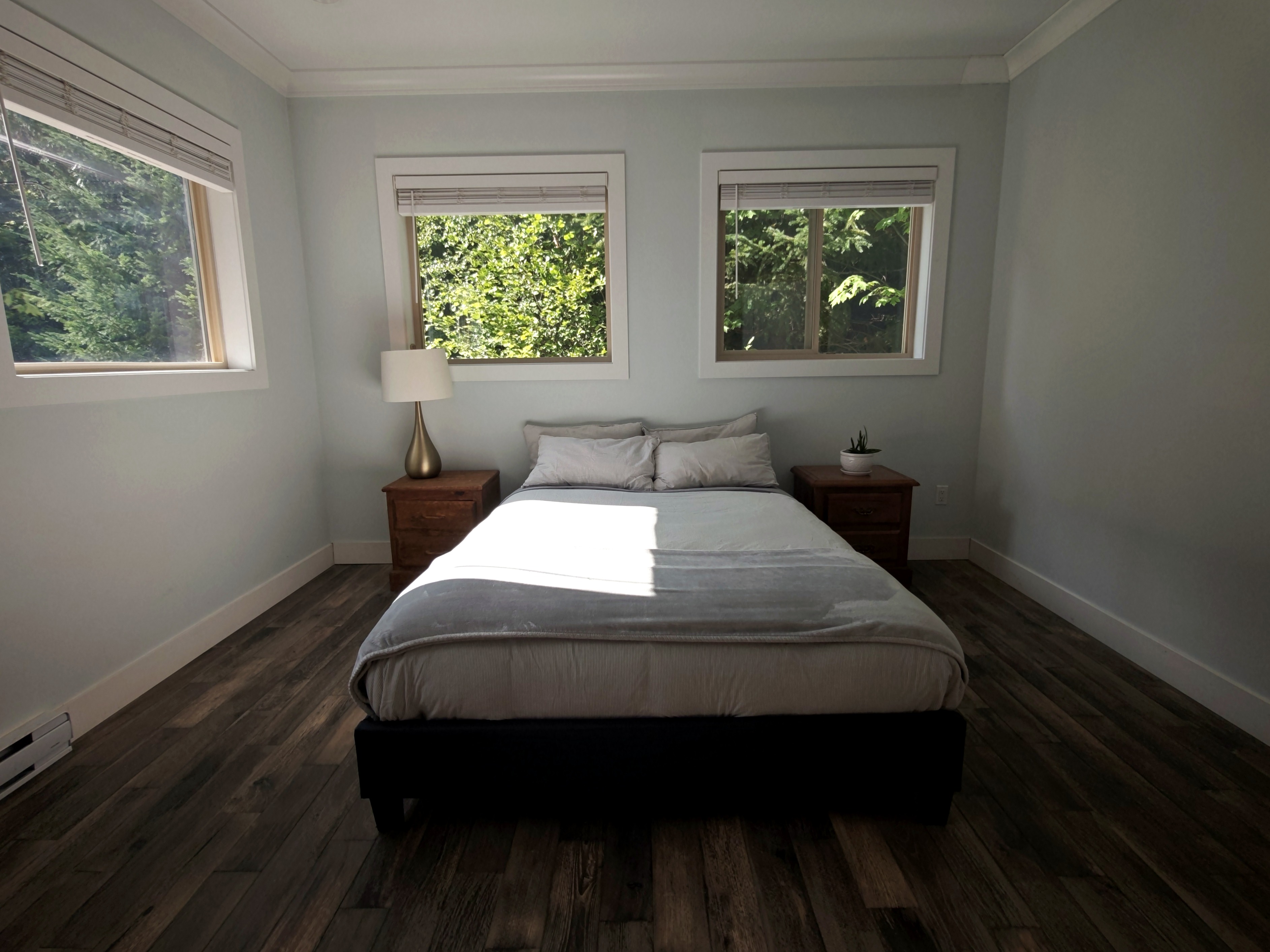 Primary bedroom suite with forest views